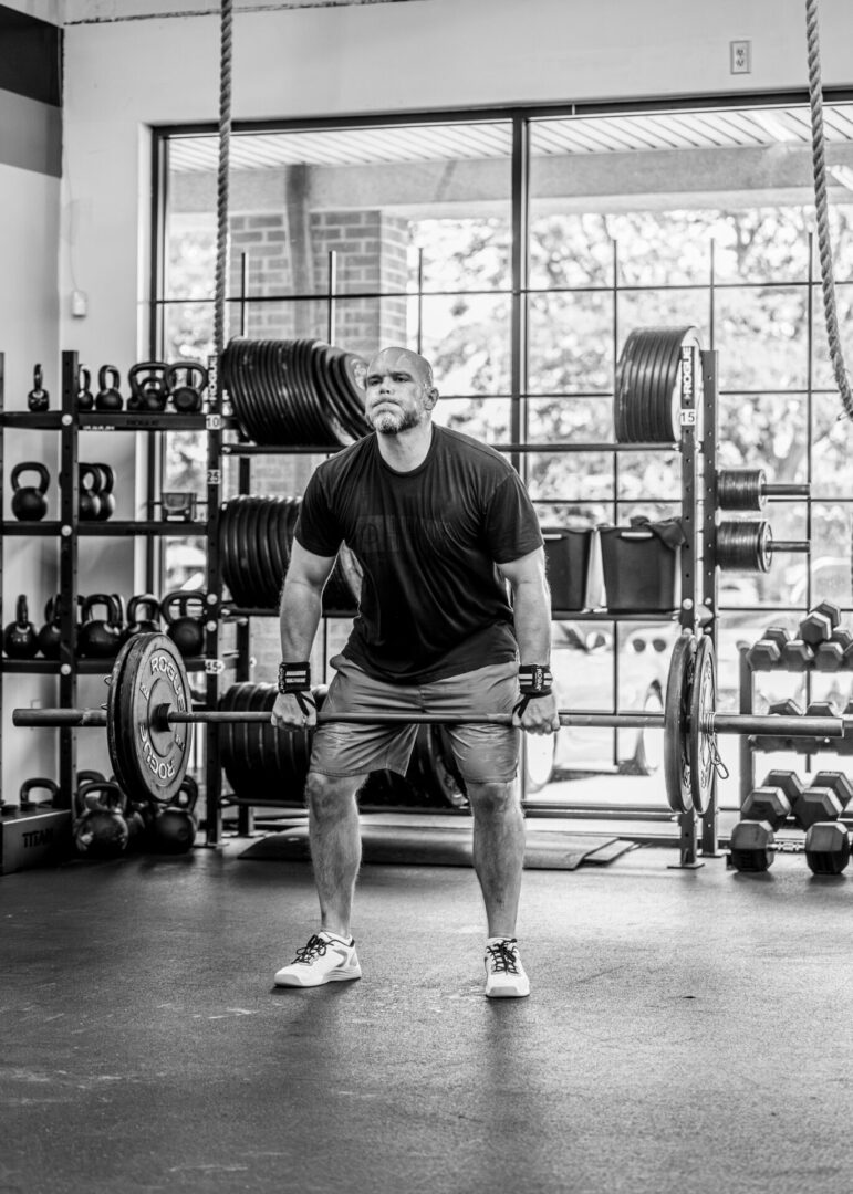 Man deadlifting in a gym.