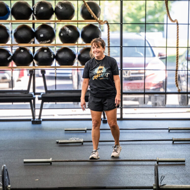 Woman smiling in CrossFit gym.